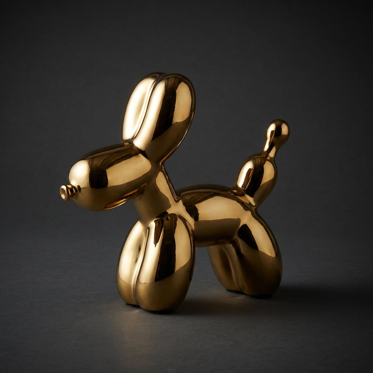 Golden Balloon Dog Sculpture — full view on dark background